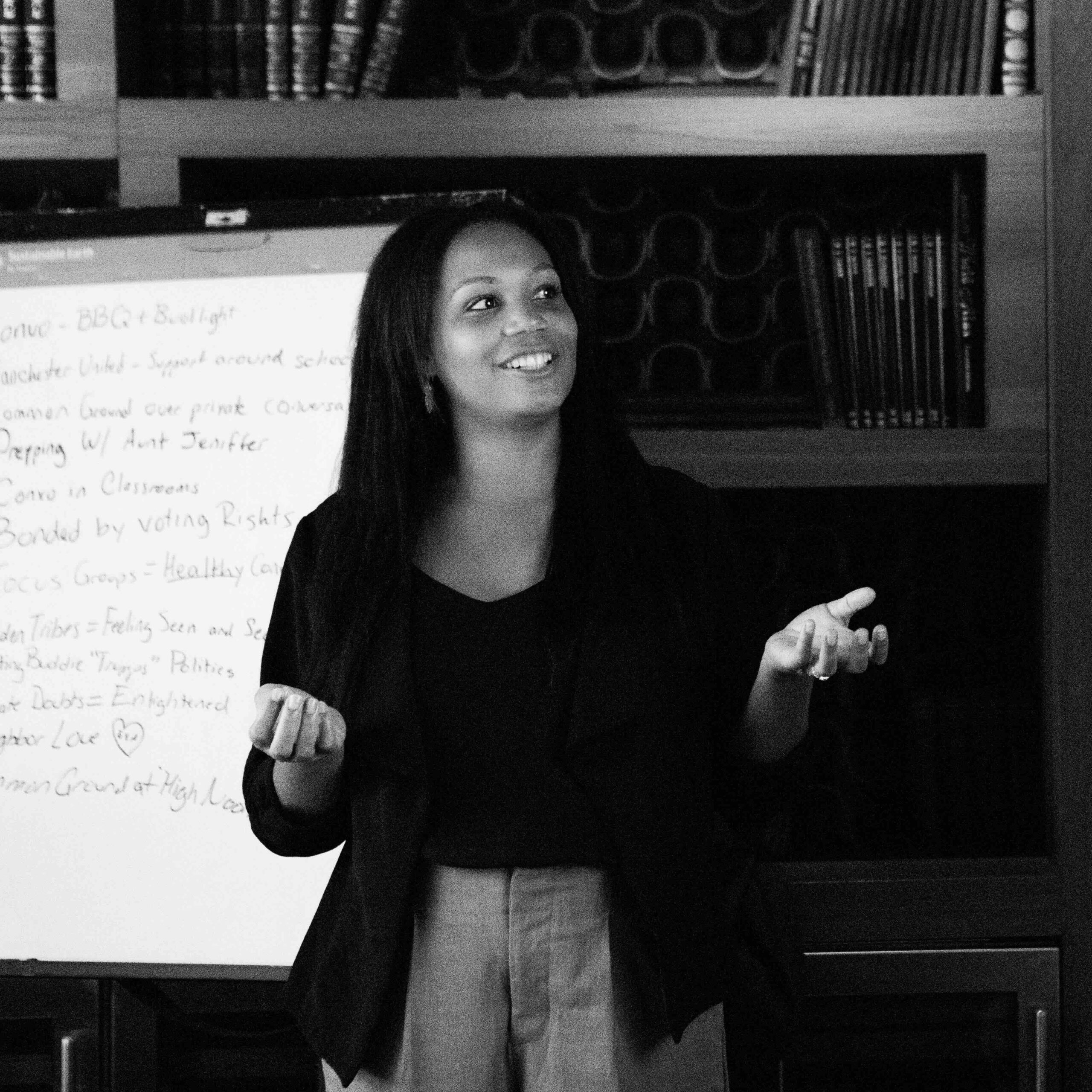 A person standing in front of a whiteboard giving a presentation.